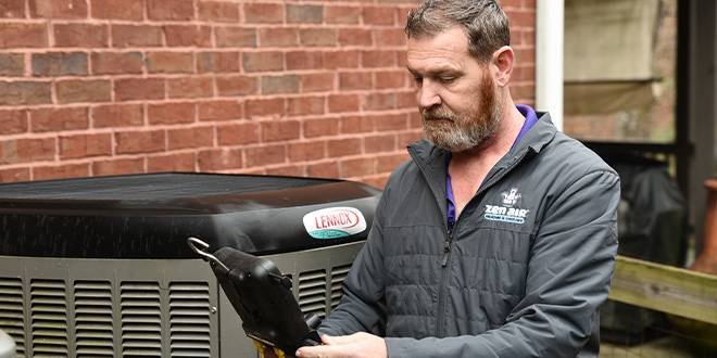 HVAC technician monitor the HVAC system and sit beside the commercial lennox ac product